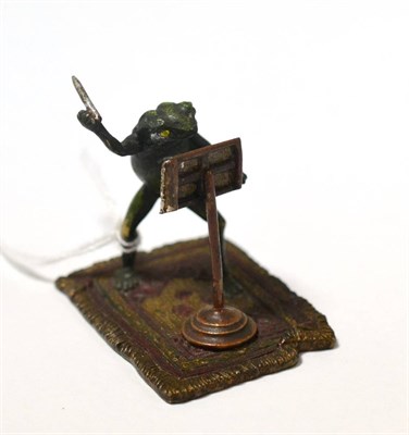 Lot 386 - A painted bronze miniature depicting a frog conductor, underside stamped Bergmann