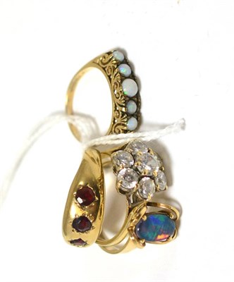 Lot 393 - A 9ct gold garnet ring, an opal ring and two other rings (4)
