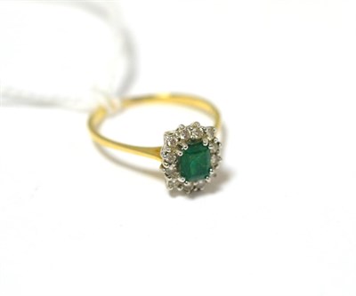 Lot 414 - An emerald and diamond cluster ring