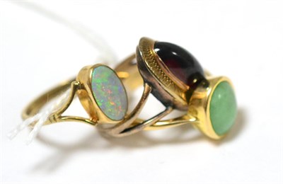 Lot 417 - A jade ring, a 9ct gold opal ring and a cabochon garnet ring (3)