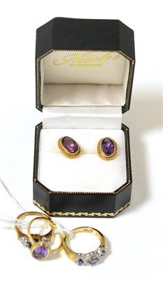 Lot 418 - A 9ct gold amethyst ring and pair of matching earrings, a sapphire and diamond ring and an amethyst