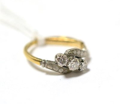Lot 440 - A diamond three stone diamond cross over ring, total estimated diamond weight 0.35 carat...