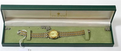 Lot 450 - A lady's bi-metal Gucci wristwatch, box and booklets