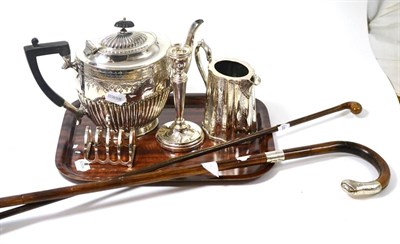 Lot 456 - A silver four division toast rack, silver candlestick, silver mounted partridge wood cane,...