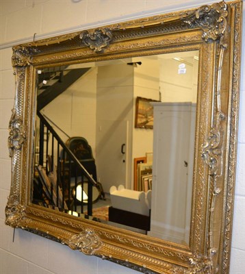 Lot 1052 - A large rectangular gilt framed mirror in the period style