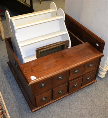 Lot 1057 - A low table fitted with an arrangement of drawers, together with three sets of shelves, a...