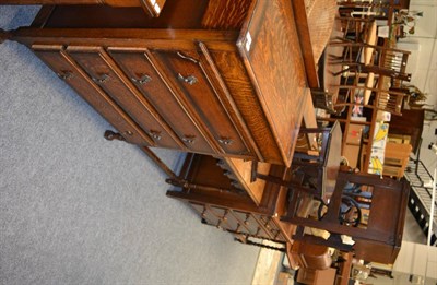 Lot 1074 - An oak four height chest of drawers, oak side table, occasional table, treadle sewing machine table