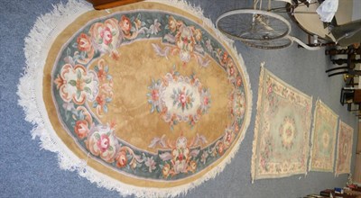 Lot 1176 - A Chinese rug of Savonnerie design, The apple green field with cream floral medallion enclosed by C