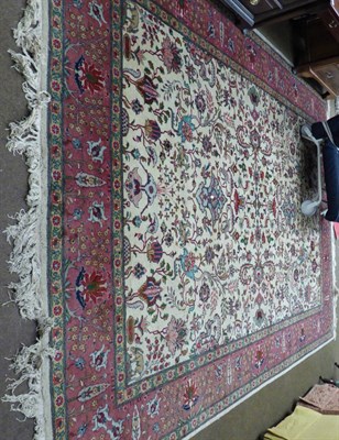 Lot 1190 - A Tabriz Carpet, Iranian Azerbaijan, the ivory field of angular vines enclosed by palmette borders