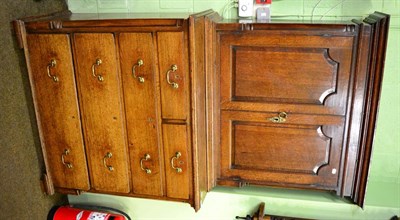 Lot 1279 - A George III oak cabinet on chest, the upper section with a pair of moulded panel doors open to...