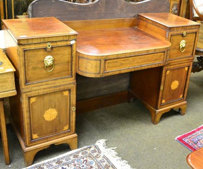 Lot 1330 - A George III mahogany pedestal sideboard with bowed central drawer, the pedestals with...