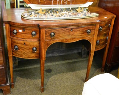 Lot 1343 - A George III mahogany break bow-front sideboard