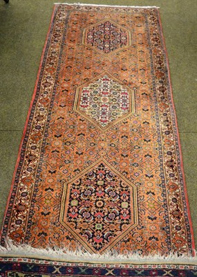 Lot 1358 - A narrow Bidjar runner, Iranian Kurdistan, the soft terracotta Herati field with a column of...