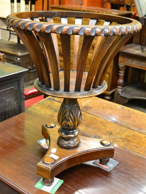 Lot 1376 - A Regency style mahogany waste paper basket on triform platform base