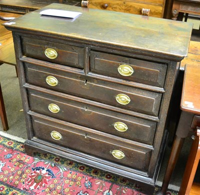 Lot 1378 - An oak panelled chest of drawers