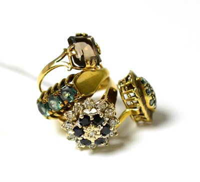 Lot 304 - A diamond and sapphire cluster ring, a smokey quartz ring and two green stone rings