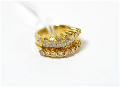 Lot 416 - ~A diamond three row ring, a row of channel set princess cut diamonds between two rows of claw...