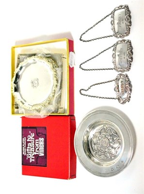 Lot 430 - A modern silver circular dish, two silver decanter labels, plated label and plated coasters