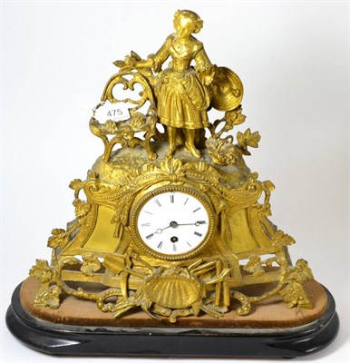 Lot 475 - A late 19th century French gilt metal mantel timepiece, modelled with a girl, tools and shells,...