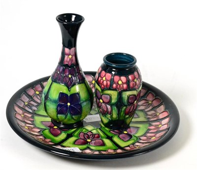 Lot 533 - Moorcroft pottery Violet pattern cabinet plate, boxed; small vase, boxed and one other vase (3)