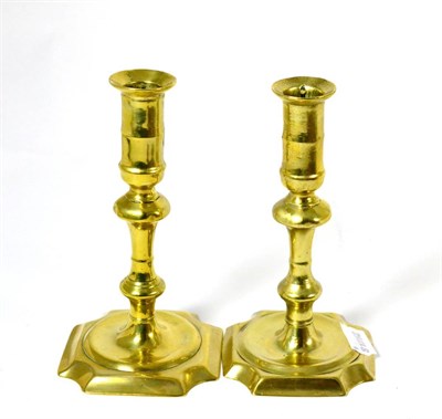 Lot 541 - A pair of Georgian brass candlesticks