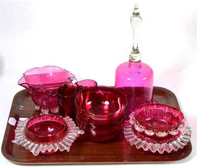 Lot 543 - A collection of cranberry glass including a large bell (on two trays)