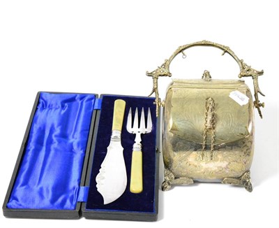 Lot 558 - A silver plated biscuit barrel together with a set of servers