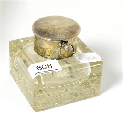 Lot 608 - A silver inkwell with lid containing a watch