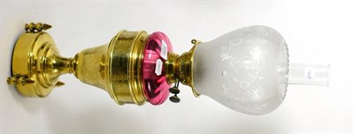 Lot 620 - A Victorian brass and cranberry oil lamp