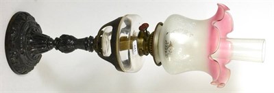 Lot 641 - An oil lamp with clear glass reservoir and etched glass shade