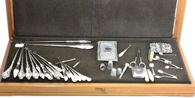 Lot 643 - A collection of silver handled button hooks, thimbles, silver backed note book, silver vesta,...