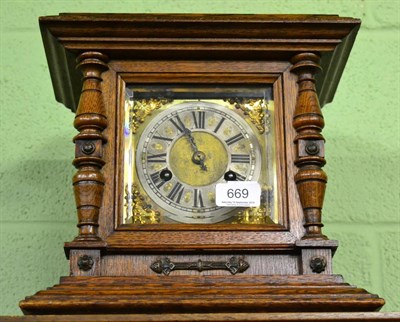 Lot 669 - An oak striking table clock