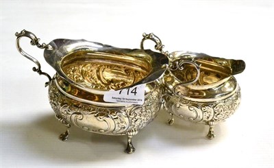 Lot 714 - An Edwardian silver sugar basin and cream jug