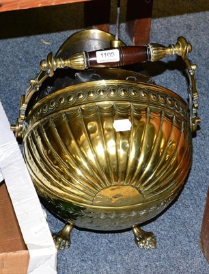 Lot 1109 - A brass coal scuttle with turned wooden handle