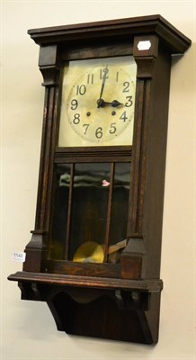 Lot 1148 - A 1930's oak wall clock with silvered dial