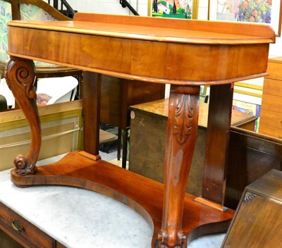 Lot 1156 - A 19th century mahogany D-end side table raised on leaf and scroll carved legs on platform base