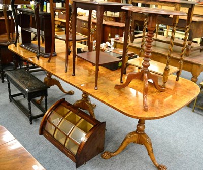 Lot 1175 - A walnut triple pedestal dining table