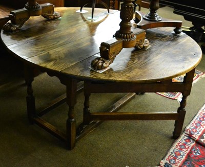 Lot 1323 - A substantial oak gateleg dining table