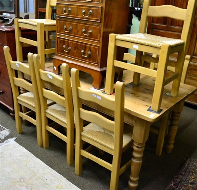 Lot 1327 - A modern pine farmhouse table and eight matching rush seated chairs