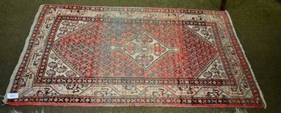 Lot 1335 - A Hamadan Rug, Persian Kurdistan, the strawberry lozenge field centred by a stepped medallion...