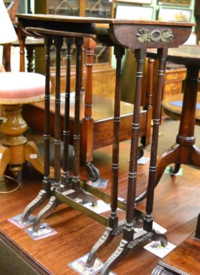 Lot 1338 - A nesting pair of Regency brass inlaid amboyna occasional tables