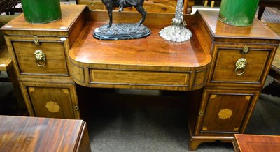 Lot 1356 - A George III mahogany pedestal sideboard with bowed central drawer, the pedestals with...