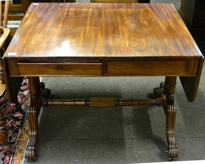 Lot 1359 - A mahogany sofa table fitted with two drawers opposed by dummies