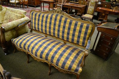 Lot 1365 - An early 20th century French style two seater open arm sofa with checkered upholstery