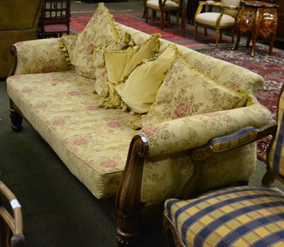 Lot 1366 - A substantial rosewood framed four seater sofa with floral upholstery and out scrolled arms