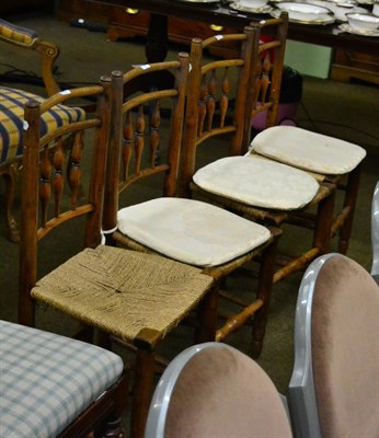 Lot 1368 - A set of four early 19th century provincial elm spindle back chairs