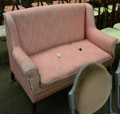 Lot 1372 - An Edwardian two seater sofa in pink upholstery