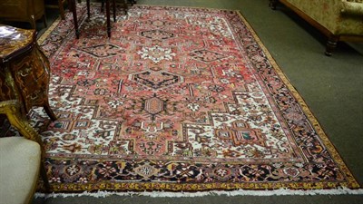 Lot 1383 - A Heriz carpet, Persian Azerbaijan, the raspberry field of angular vines around a cruciform...