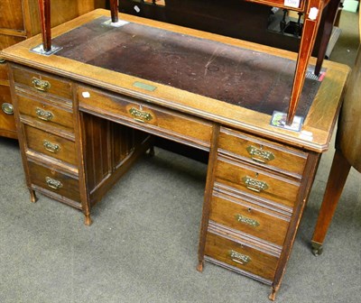 Lot 1400 - An oak leather top desk