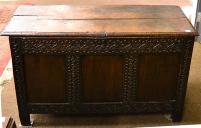 Lot 1419 - A late 17th century oak coffer with three-panel front, partially carved, internal candle-box